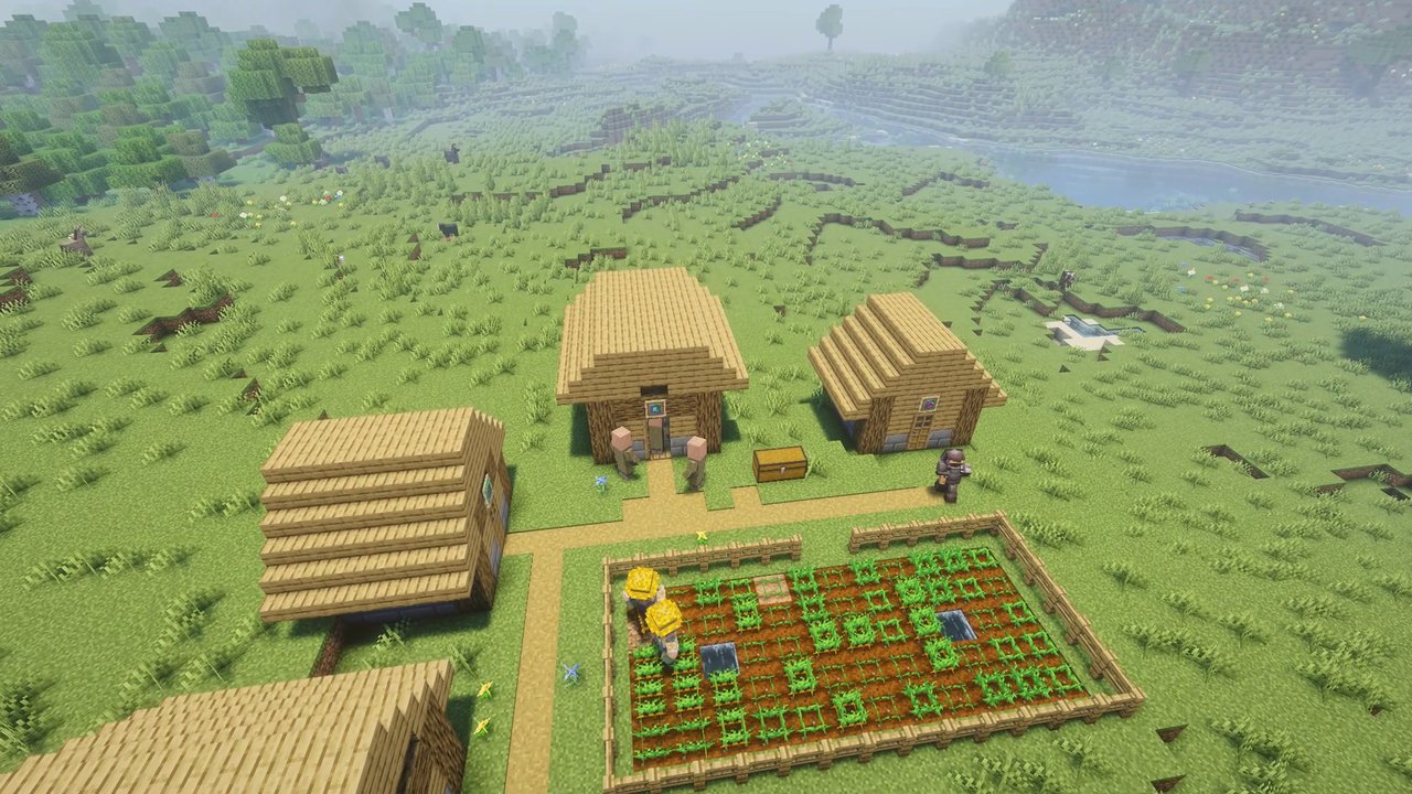 A young village: a few houses, a fenced field and villagers about
